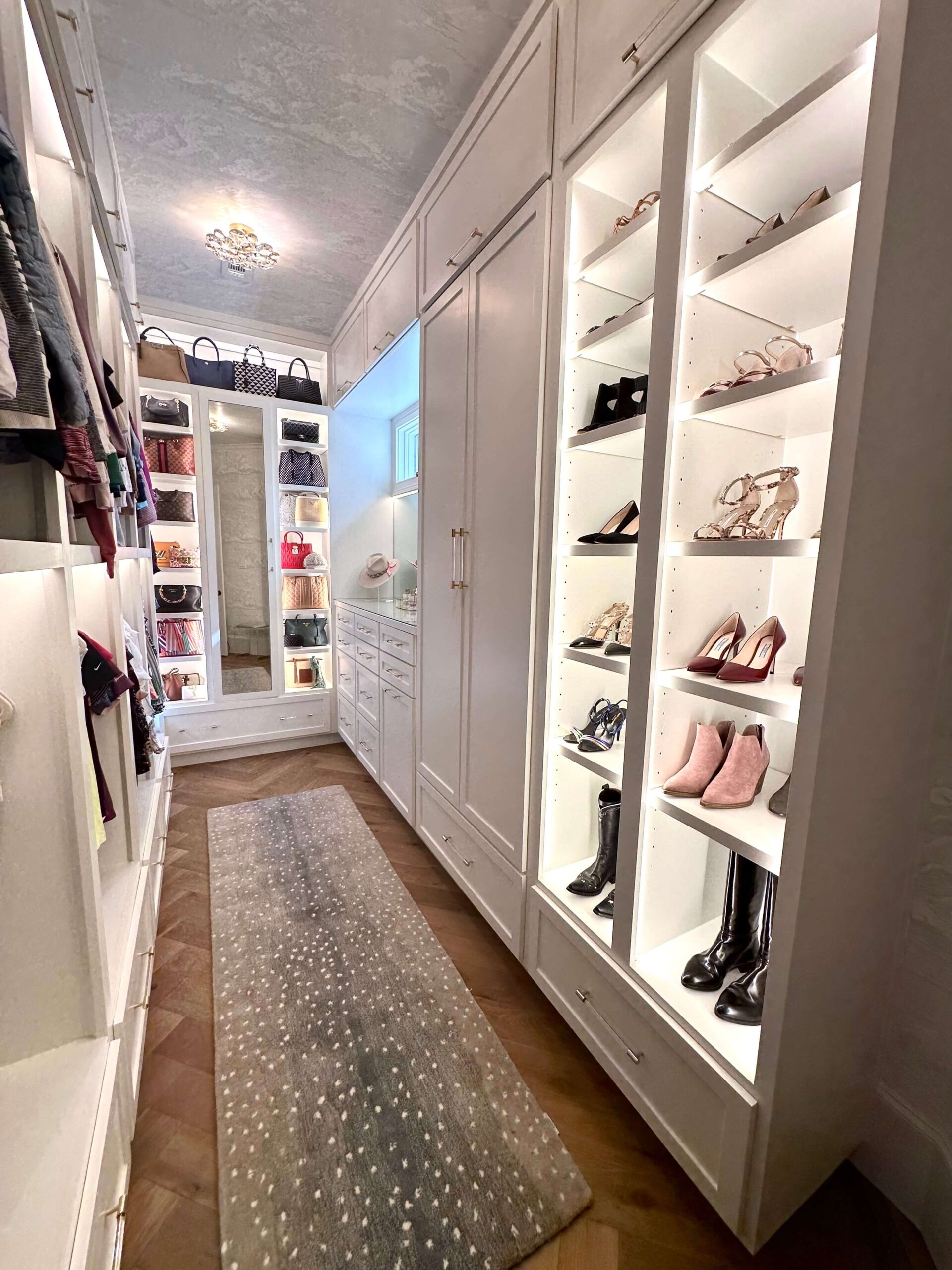 White feminine closet with lights and shoes